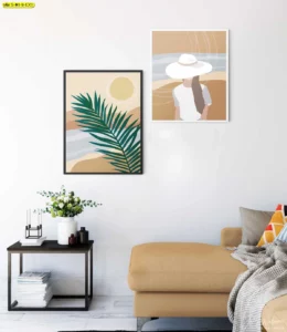 มุมนั่งเล่นสีทรายกับโซฟาเข้ามุมและภาพใบปาล์มคู่หญิงสวมหมวก โทนซัมเมอร์ผ่อนคลาย