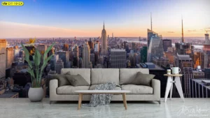 ภาพสกายไลน์ตึกสูงเวลาพระอาทิตย์ตกพิมพ์ผ้าแคนวาสเต็มผนังสร้างแรงบันดาลใจและสื่อถึงความทะเยอทะยานให้กับเลานจ์สำนักงานสไตล์คอนเทมโพรารีอย่างลงตัว